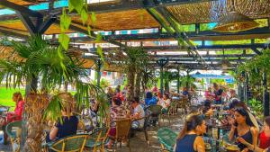a group of people sitting at an outdoor restaurant at Piata Unirii Central Apartments in Iaşi