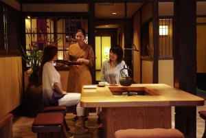 a group of three women standing in a room at Taikyourou in Miyazu