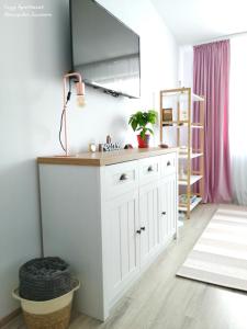 een keuken met een witte kast en een lamp bij Cozy Apartment Narciselor Suceava in Ipoteşti