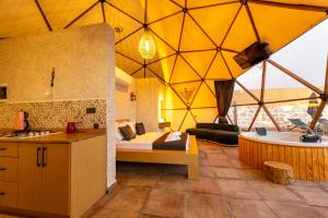 a room with a bed and a tub in a tent at Kalkan Dome Suites & Deluxe-Glamping Holiday in Kalkan in Kaş