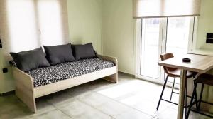 a room with a couch and a table and a window at Yucca Studio, beautiful apartment with garden in Ropanianá