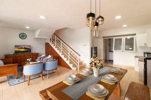 uma cozinha e sala de estar com mesa e cadeiras em VILLA KELUARGA Syariah Resor Dago Pakar Bandung - View Bukit em Bandung