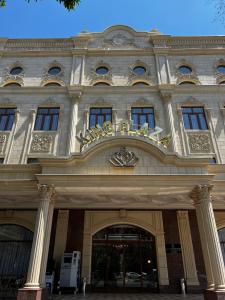 a building with a sign on the front of it at King Plaza in Tashkent