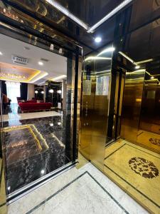 a lobby with a glass door and a red couch at King Plaza Hotel in Tashkent +90 photos