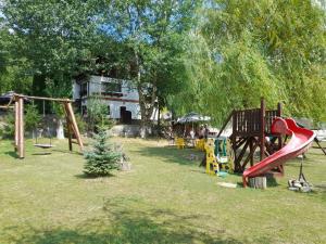 a park with a playground with a slide at Pensiunea Trei Ponei in Corbeni