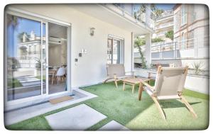 a patio with chairs and a table on a balcony at Le Vallaya Suites & Spa in Menton