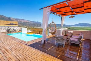 a deck with a swing and a swimming pool at Kalkan Dome Suites & Deluxe-Glamping Holiday in Kalkan in Kas