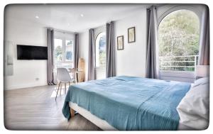 a bedroom with a bed and a table with chairs at Le Vallaya Suites & Spa in Menton