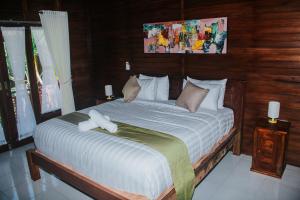Kurnia Guest House & Spa客房内的一张或多张床位
