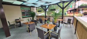 a restaurant with tables and chairs on a patio at PONI NAKLO - Sobe Marinšek in Naklo