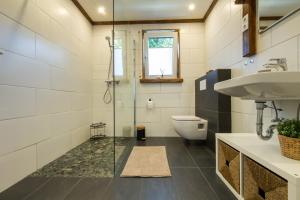 a bathroom with a shower and a toilet and a sink at Ferienwohnung Landparadies im Sauerland in Bestwig +23 photos