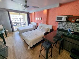 a hotel room with a bed and a couch and a table at Cancun Plaza Condo Mexico in Cancún +135 photos