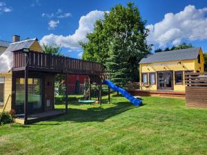 a playground in a yard next to a house at Tiny house near Viljandi lake in Viljandi