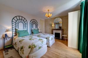 Postelja oz. postelje v sobi nastanitve Maison de la Garenne & Spa