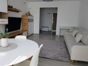 salon z kanapą i stołem w obiekcie Alexa Apartament w mieście Târgu Mureş