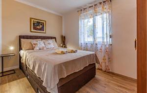 a bedroom with a bed with two pillows on it at 4 Bedroom Cozy Home In Marcana in Marčana