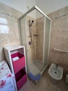 a bathroom with a shower and a toilet and a sink at La casa di Anna in Torricella
