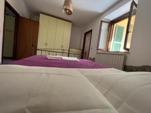 a bedroom with a bed with two towels on it at La casa di Anna in Torricella