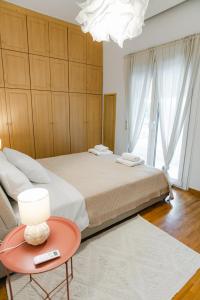 a bedroom with a large bed and a red table at Flat 126 in Alexandroupoli