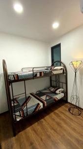 two bunk beds in a room with a lamp at #2.1 Jazz Suites Large Bed Vivacity Kuching 3rooms in Kuching