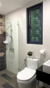 a bathroom with a toilet and a glass shower at #2.1 Jazz Suites Large Bed Vivacity Kuching 3rooms in Kuching