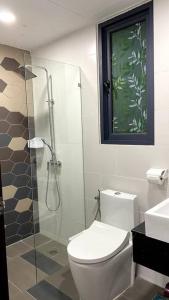 a bathroom with a toilet and a glass shower at #2.1 Jazz Suites Large Bed Vivacity Kuching 3rooms in Kuching +29 photos
