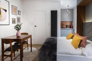 a bedroom with a bed and a desk and a table at Hillside7 Micro-Apartment 7 in Bielsko-Biała
