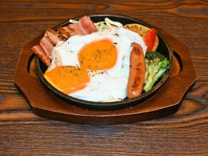 a plate of food with eggs and bacon and broccoli at APA Hotel Asakusa Shin Okachimachi Ekimae in Tokyo