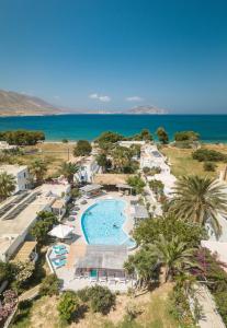 an aerial view of a resort with a swimming pool and the ocean at Lakki Village in Aegiali