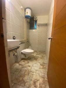 a bathroom with a toilet and a sink at hotel green city in Chennai