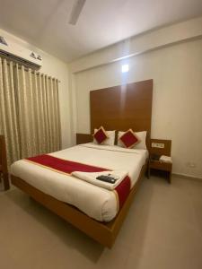 a bedroom with a large bed in a room at hotel green city in Chennai