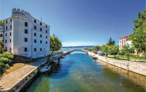 a bridge over a river with boats in the water at Awesome Apartment In Tribalj With Kitchen in Tribalj