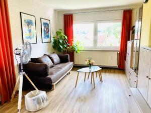 a living room with a couch and a table at Alraftsblick in Waldeck