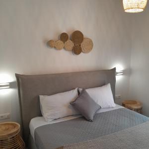 a bedroom with a bed with two plates on the wall at Brand new flat near de bosset bridge, Argostoli in Argostoli