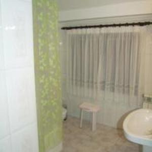 a bathroom with a sink and a tub and a toilet at Pension Gades in Cabezón de la Sal