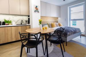 a kitchen and a dining room with a table and chairs at Hillside7 Micro-Apartment 16 in Bielsko-Biała