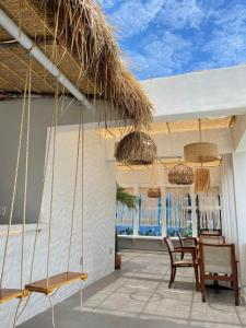 a room with chairs and a table and some windows at VV House Quy Nhon in Quy Nhon
