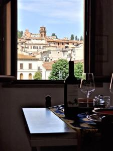 a bottle of wine sitting on a table next to a window at APPARTAMENTS SAN FRANCESCO in Castelfiorentino