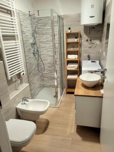 a bathroom with two sinks and a shower and two toilets at Milan - San Siro Apartment in Milan