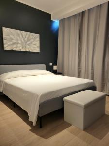 a bedroom with a large white bed and a window at Milan - San Siro Apartment in Milan