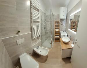 a white bathroom with two sinks and a shower at Milan - San Siro Apartment in Milan