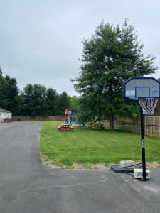 a basketball hoop in a park with a playground at Lakeshore Suites in North Bay