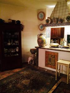 a room with a kitchen with a stove and a counter at B&B Martina in Taormina