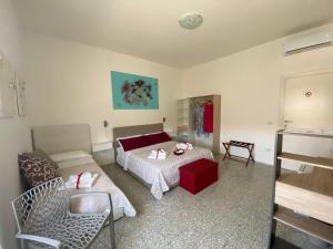 a bedroom with a bed and a table and chairs at Rossocorallo Rooms in Alghero