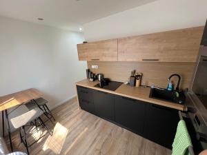 a kitchen with a sink and a counter top at -Self-check- brand new apartment White-Diamond in Nitra