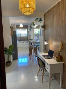 a kitchen and dining room with a laptop on a desk at Centre de Juan les pins 100m plages Easy Check-in in Juan-les-Pins