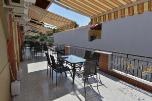 a patio with a table and chairs on a balcony at Anna Christina Apartments in Metamorfosi