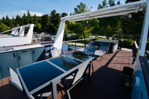 a table and chairs on a deck of a boat at mariTIME deluxe in Portorož