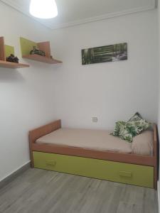 a small bedroom with a bed with at Apartamento espacioso, nuevo, luminoso y acogedor in Casar de Cáceres