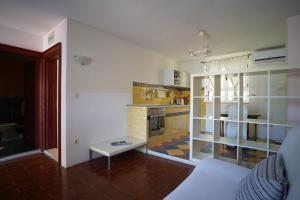 a living room with a couch and a kitchen at Sea House Mljet in Polače